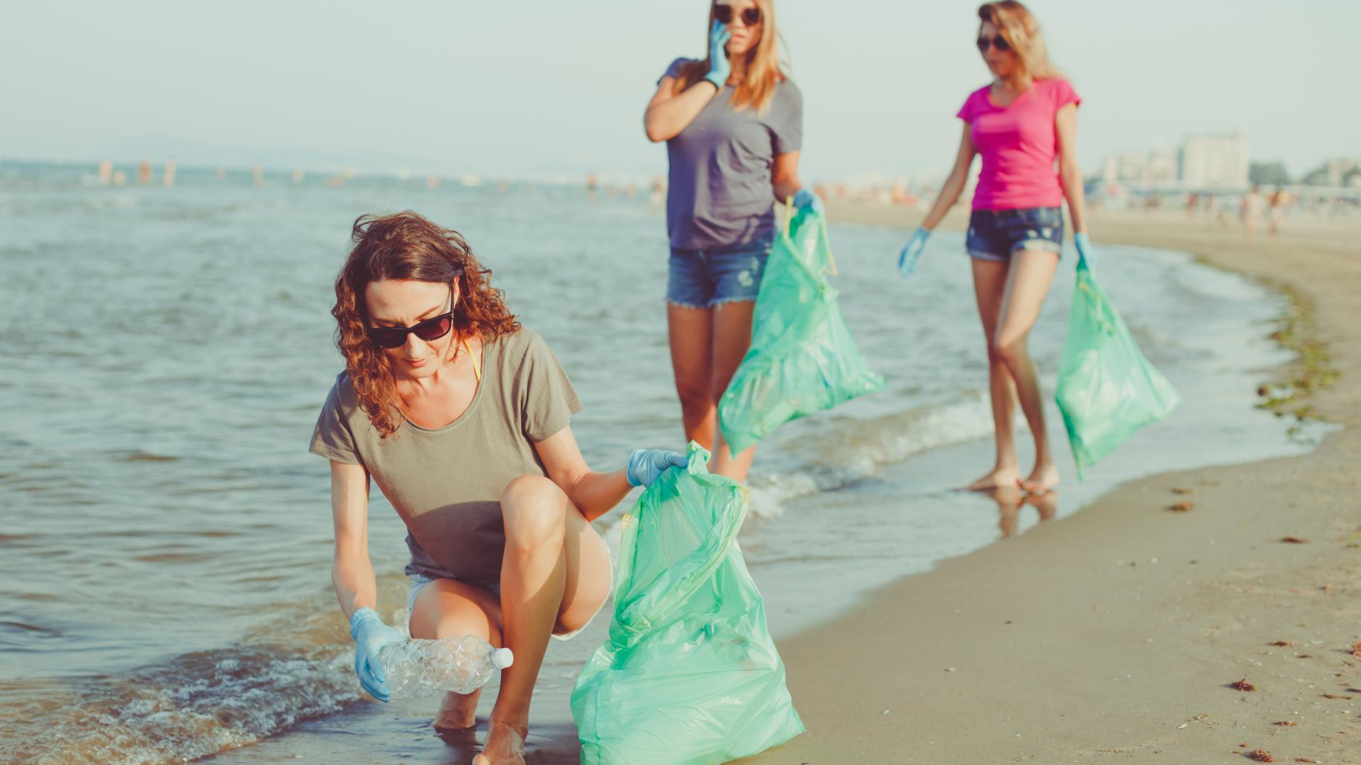 Frauen sammeln Plastik am Strand