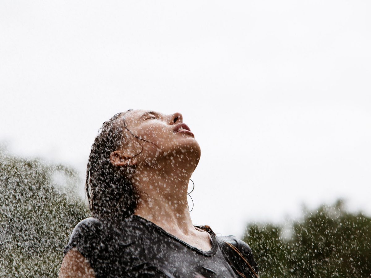 Frau steht im Regen