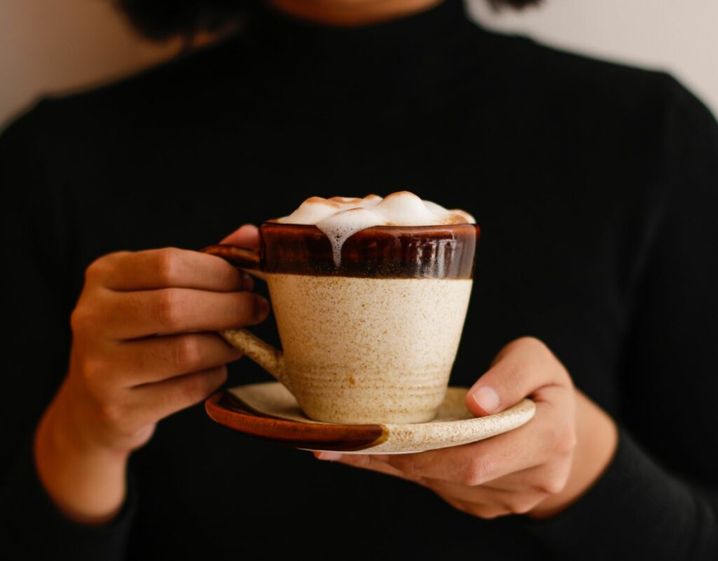 Frau hält Kaffee in der Hand Kaffee mit Alkohol