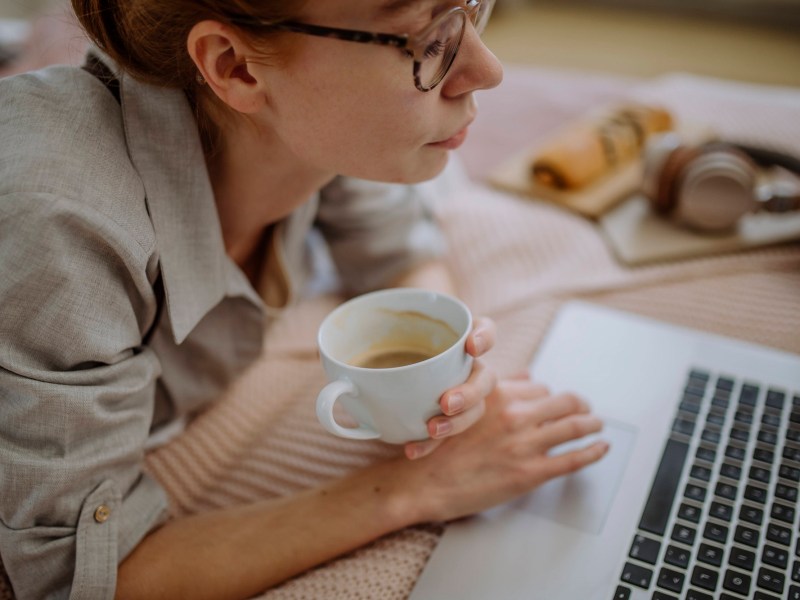 Frau mit Kaffee am Laptop