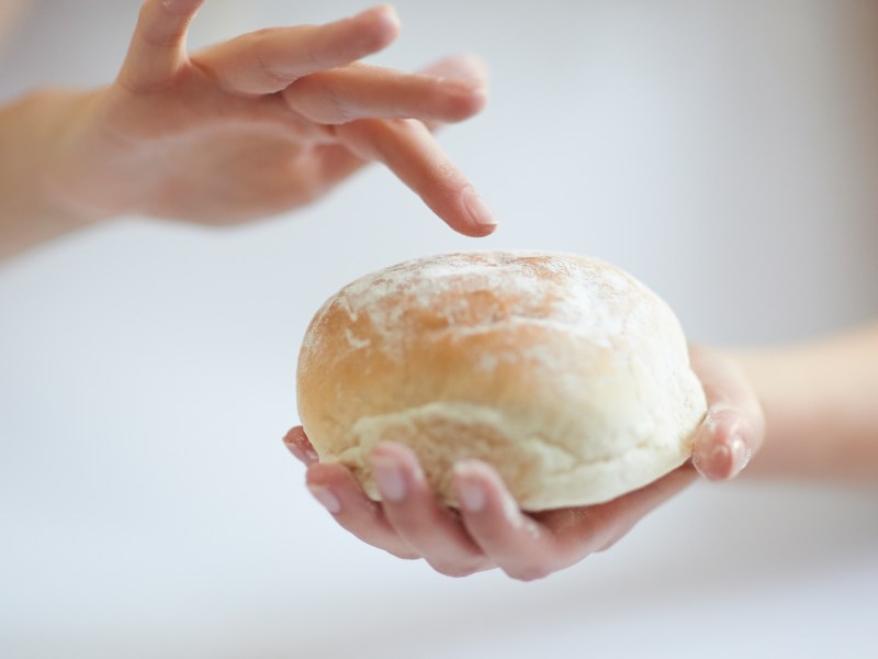 Frau hält Brötchen fest