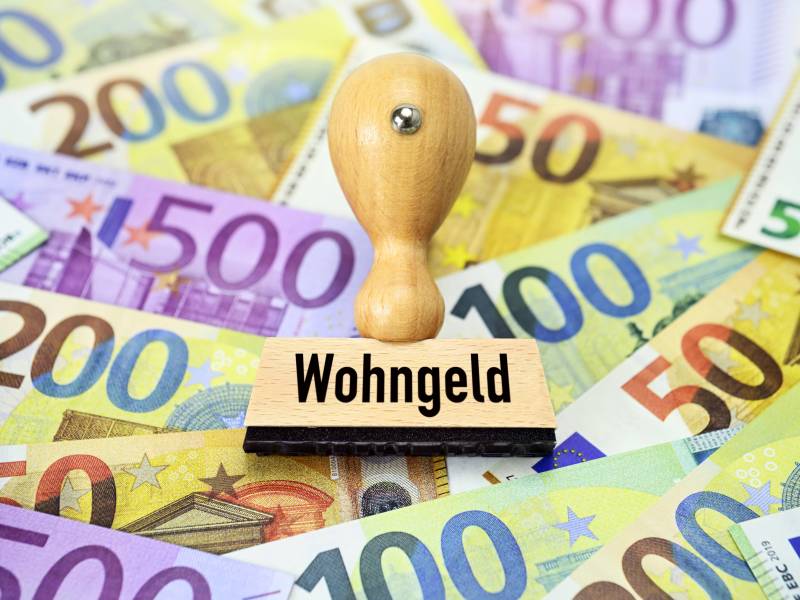 Ein Stempel mit der Aufschrift "Wohngeld" liegt auf Geldscheinen.