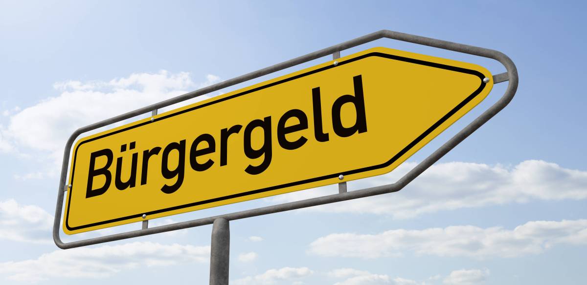 Auf einem gelben Schild steht das Wort "Bürgergeld".