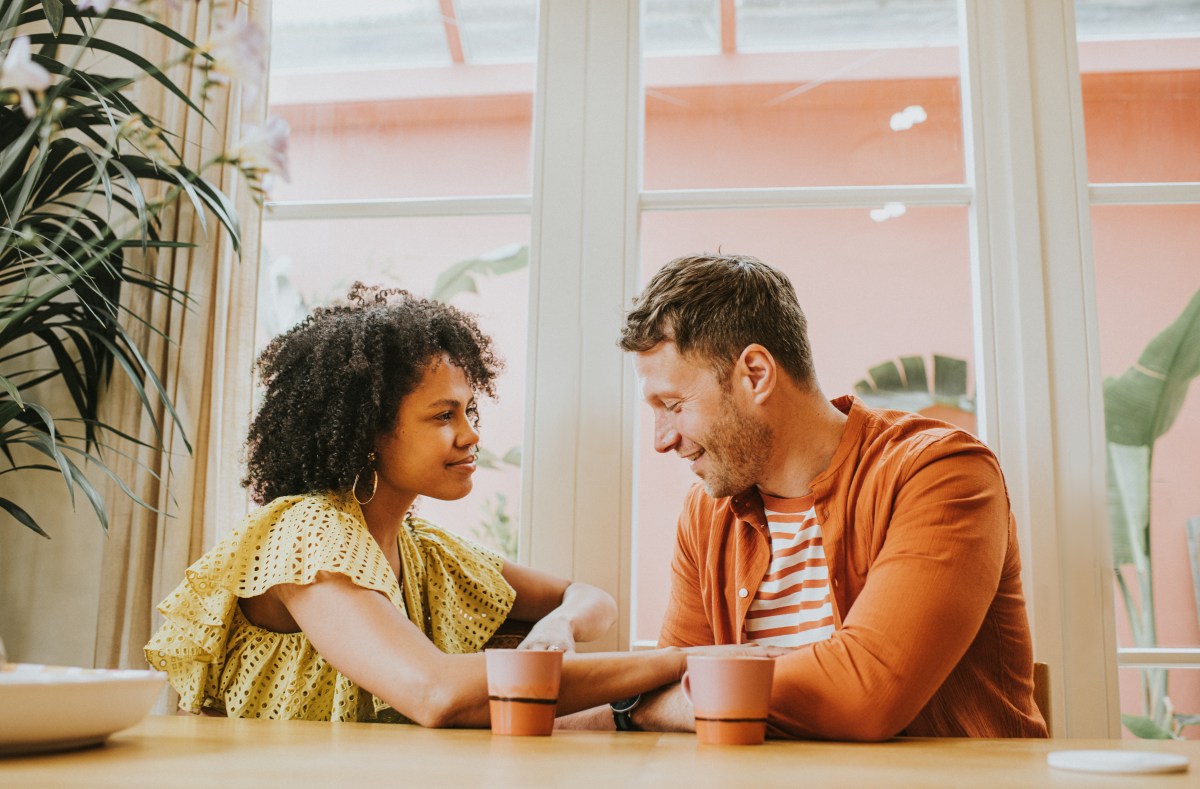 Frau und Mann sitzen sich bei einem Kaffee für ihr erstes Date gegenüber